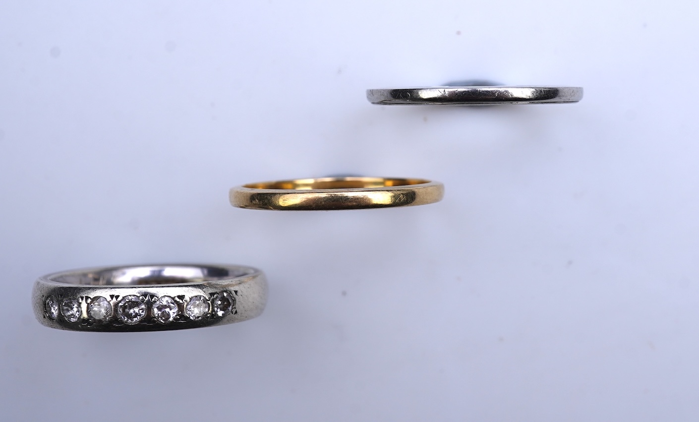 A diamond ring and two gold wedding rings